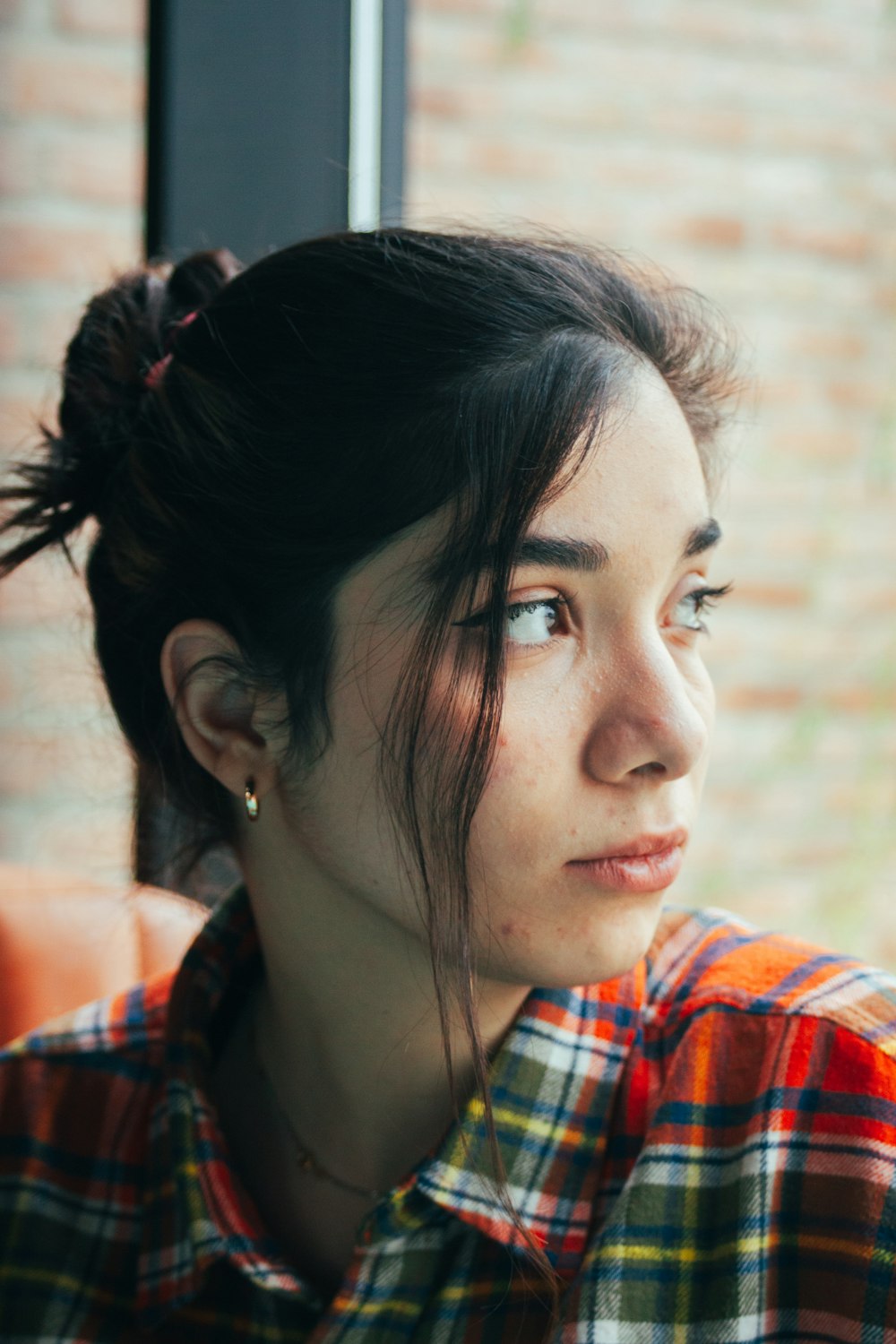 a woman with a messy bun in her hair