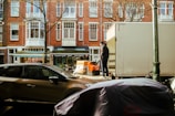 a man standing next to a moving truck on a city street