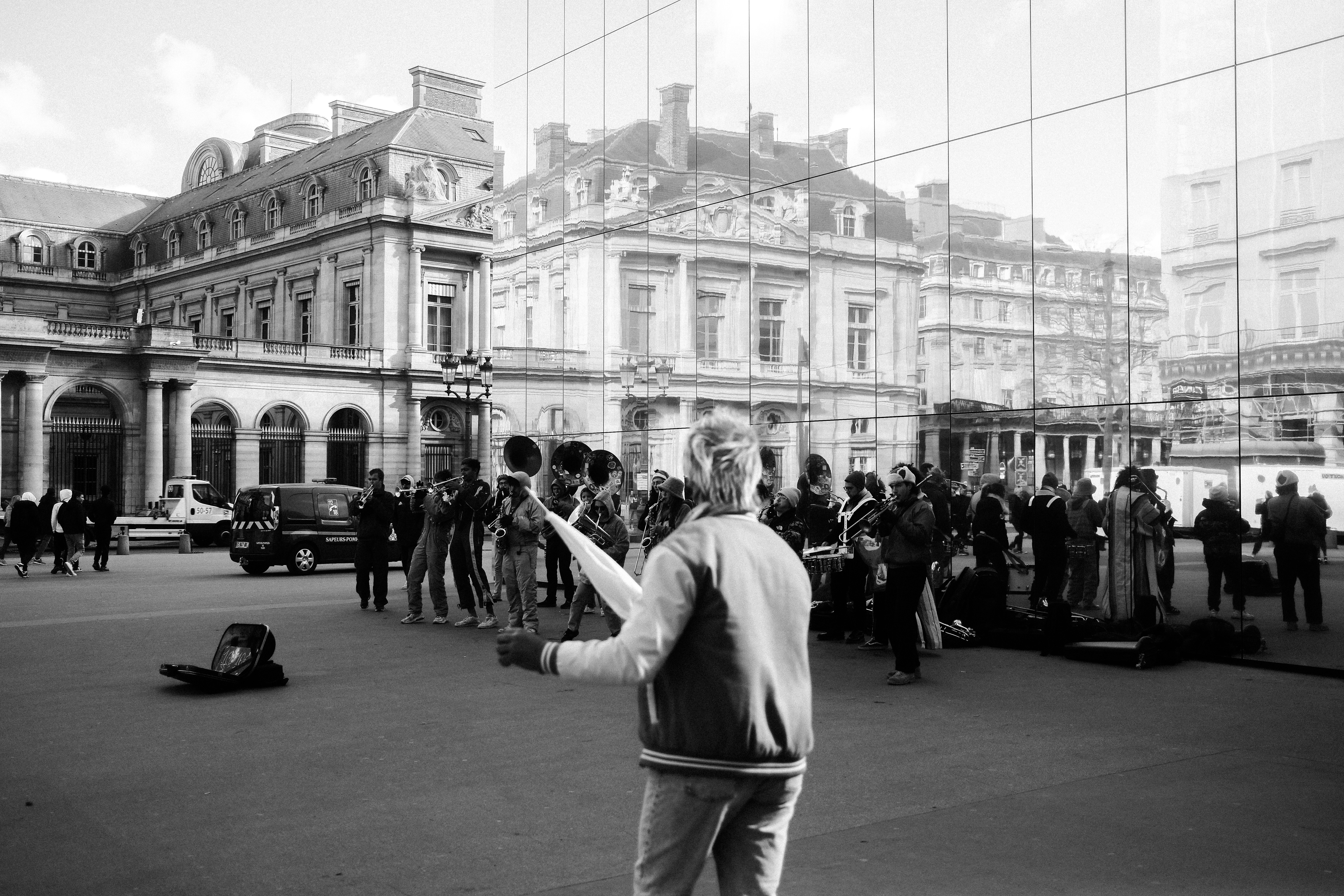 a man holding a tennis racquet in front of a crowd of people, 