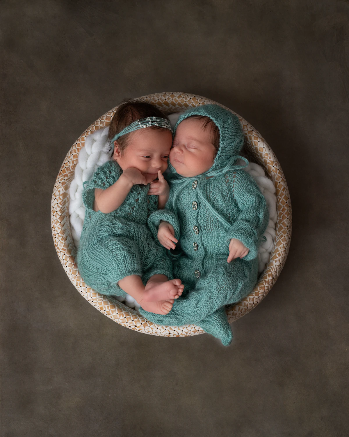 Newborn twins lying peacefully side by side