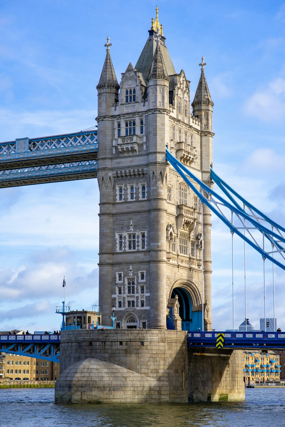 a tall tower with a bridge in the background