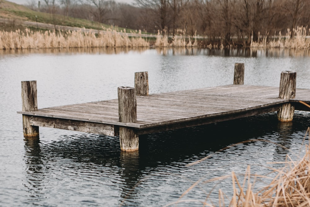 a wooden dock sitting in the middle of a lake