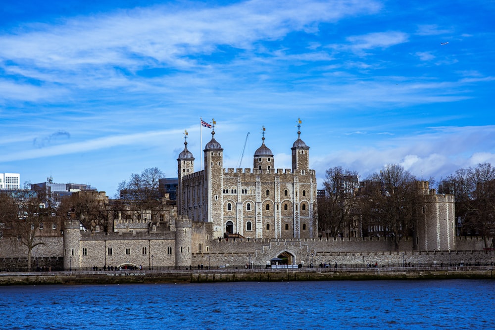 a large castle sitting next to a body of water