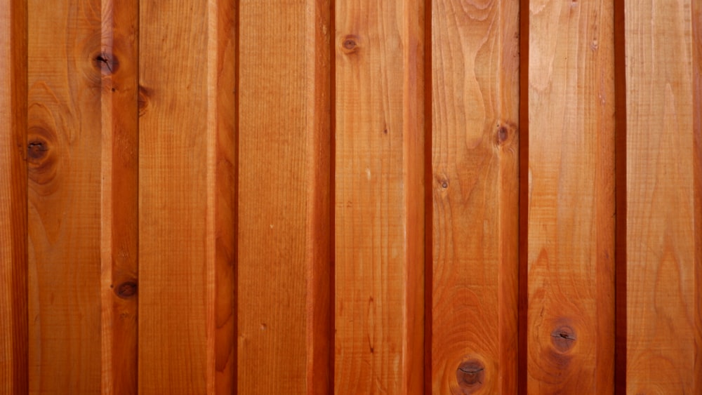 a close up of a wooden fence with a red stop sign