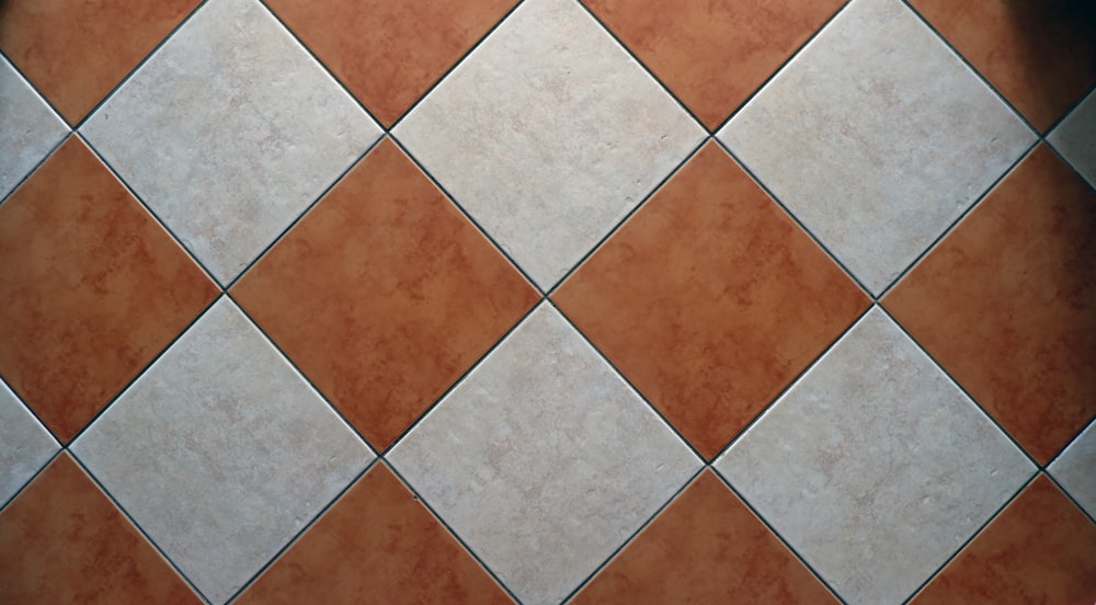 a close up of a tiled floor with a red and white checkerboard pattern