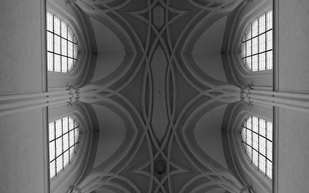 a black and white photo of the ceiling of a building