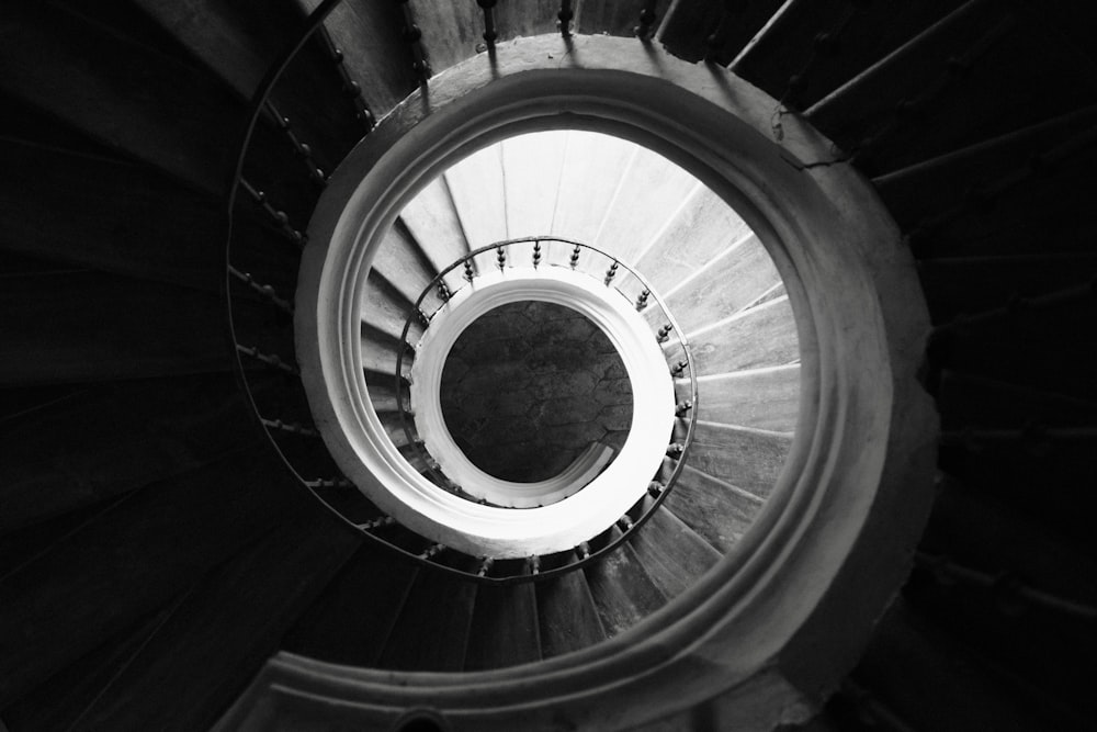 a black and white photo of a spiral staircase