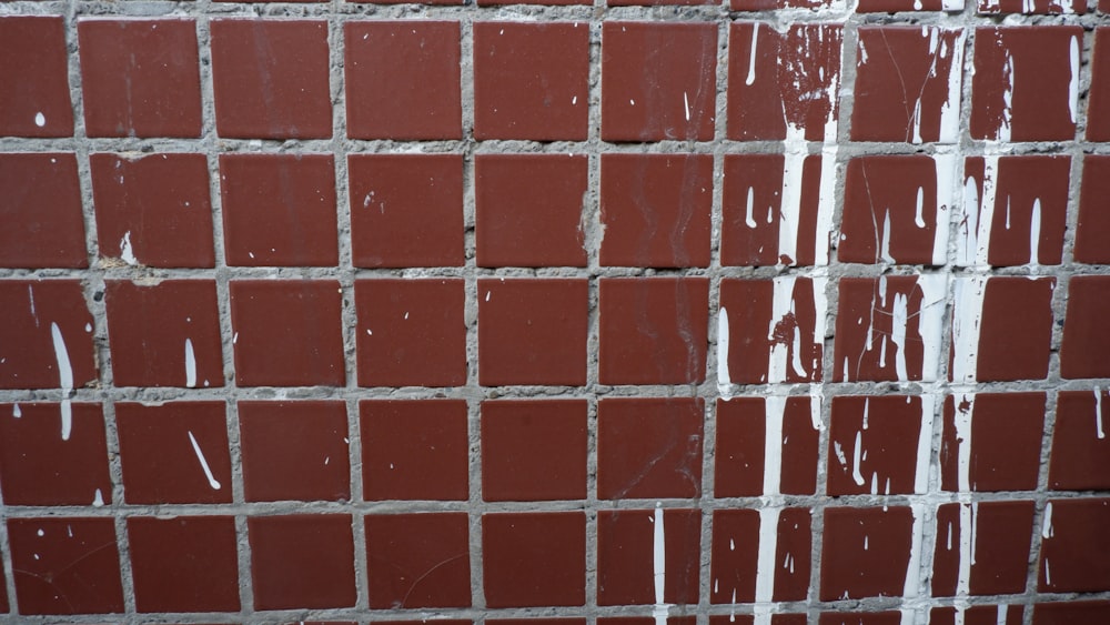 a close up of a brick wall with water running down it