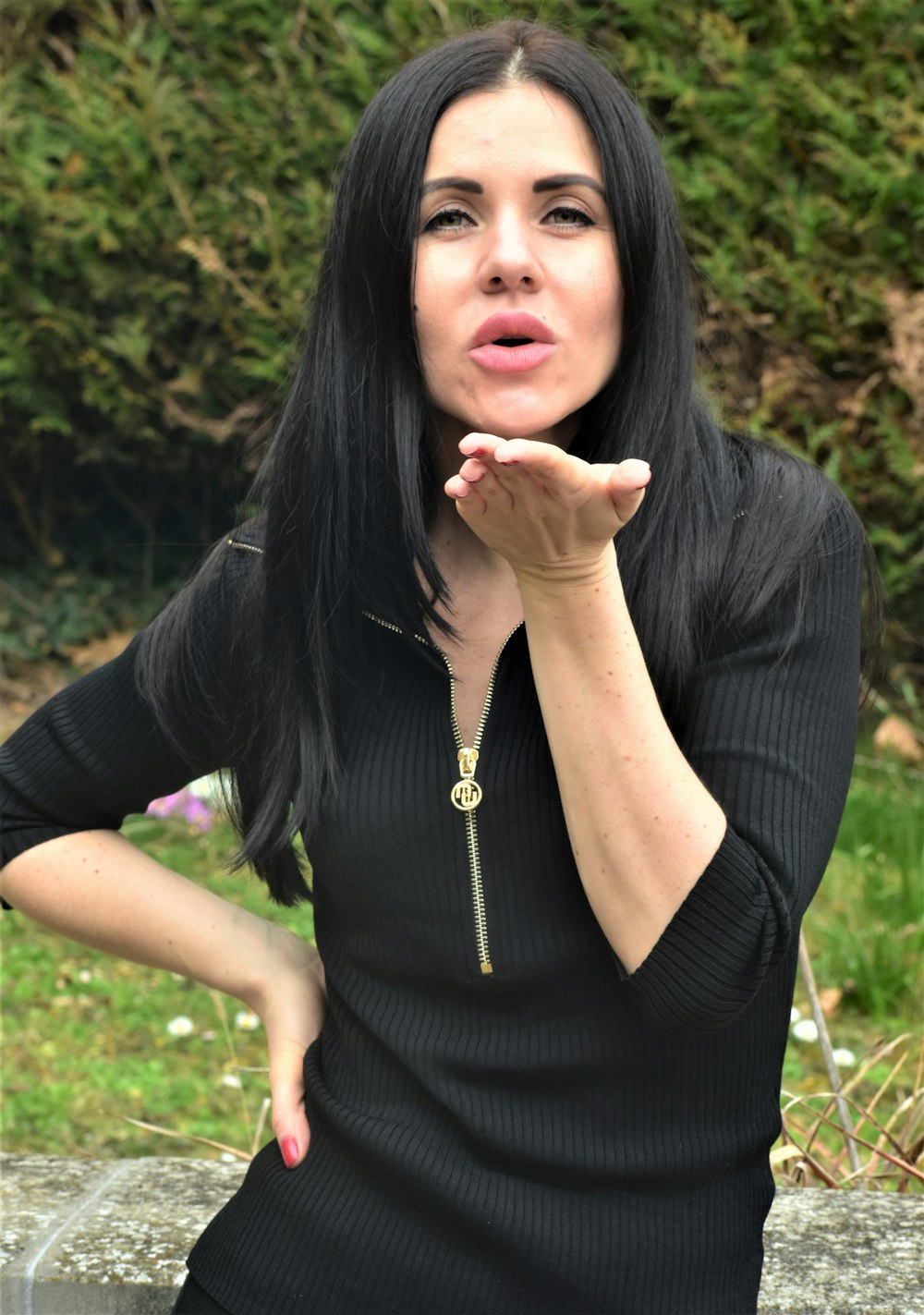 a woman with long black hair is posing for a picture