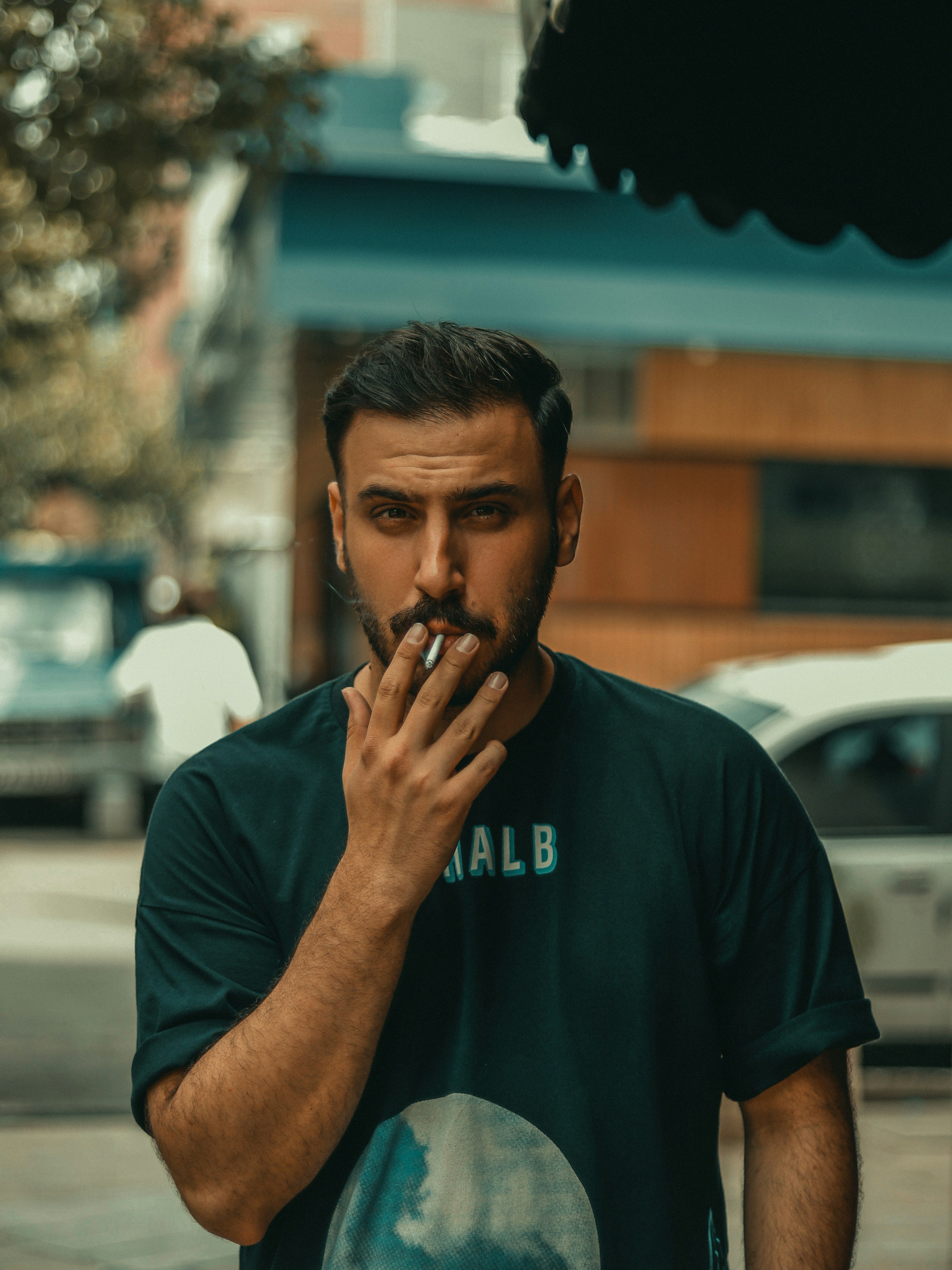 a man smoking a cigarette on a city street