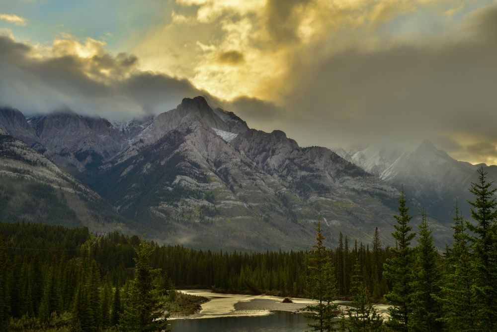 a mountain range with a lake in the foreground