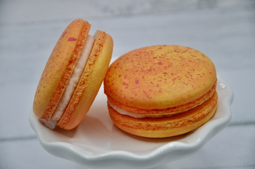 a white plate topped with two macaroons on top of each other