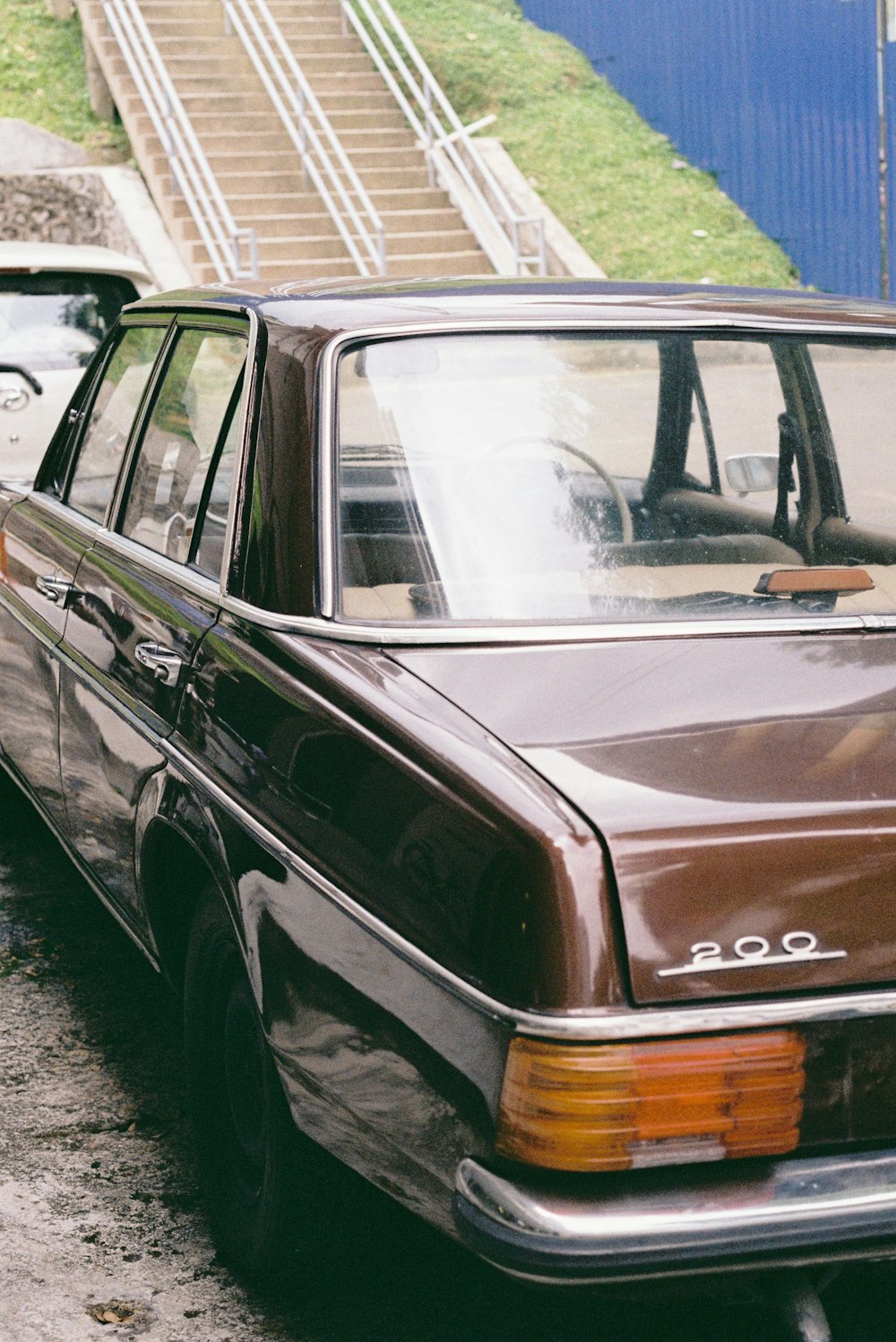 a brown station wagon parked on the side of the road