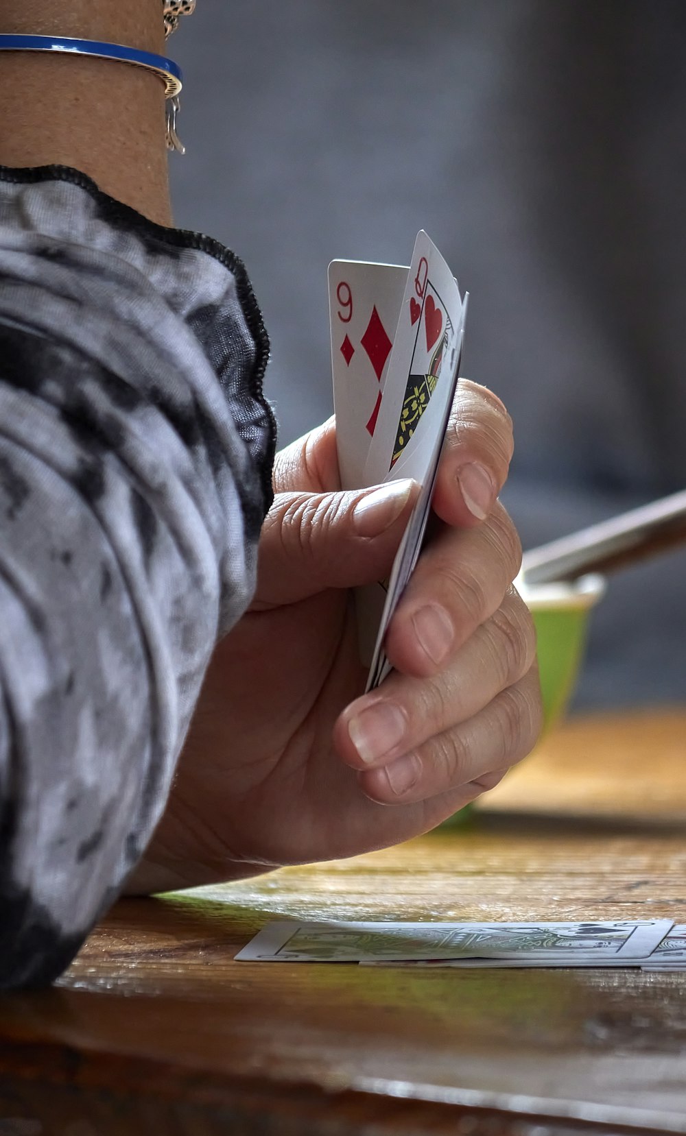 a person holding a playing card in their hand