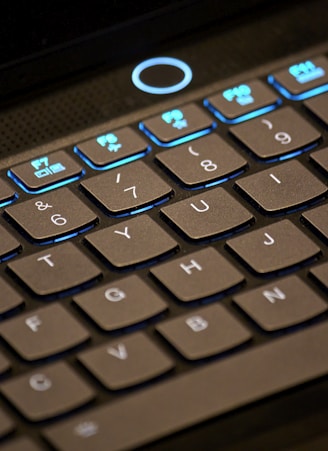 a close up of a keyboard with a blue light