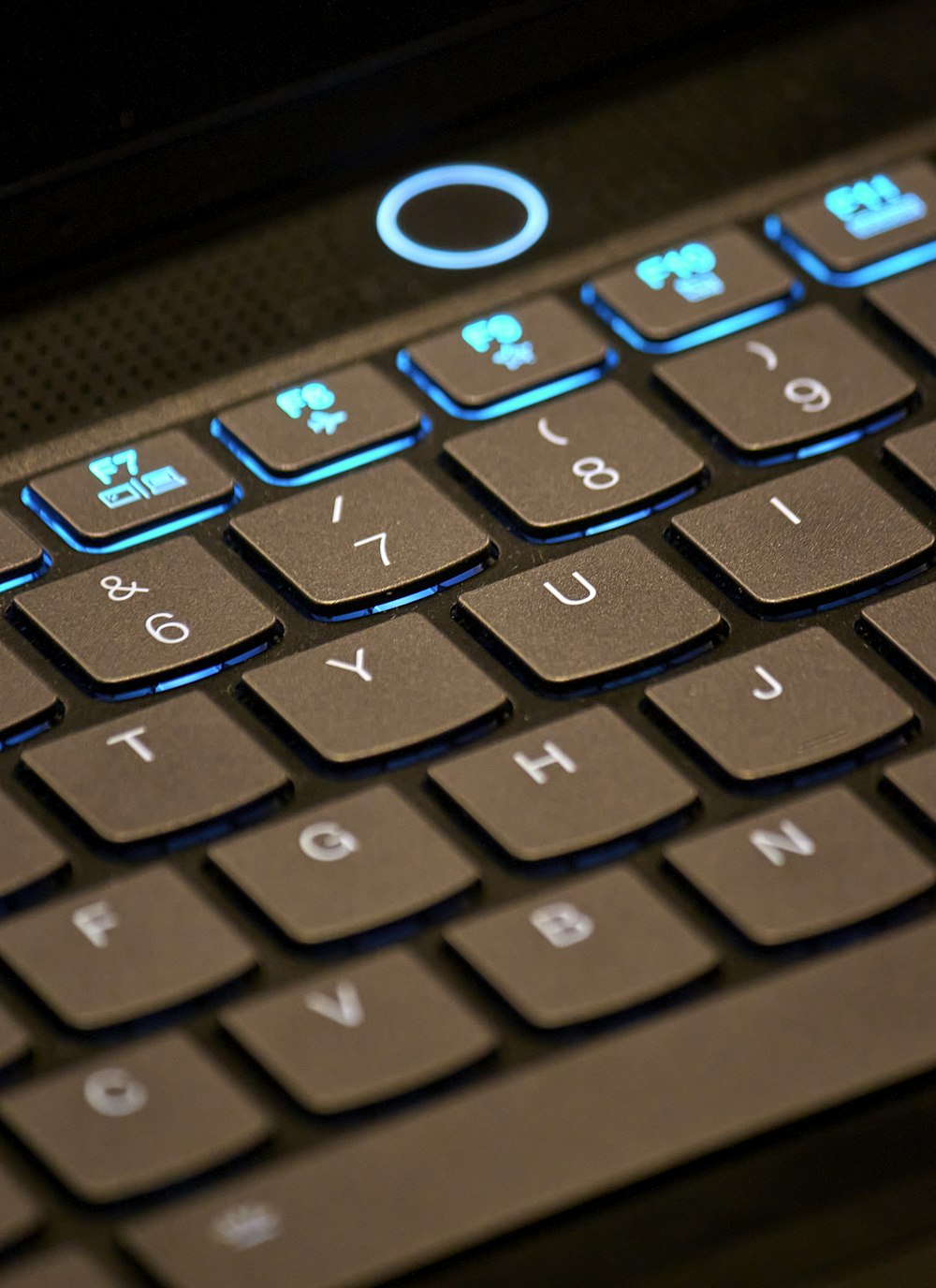 a close up of a keyboard with a blue light