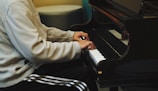 A student smiling while practicing a lively jazz piano piece.