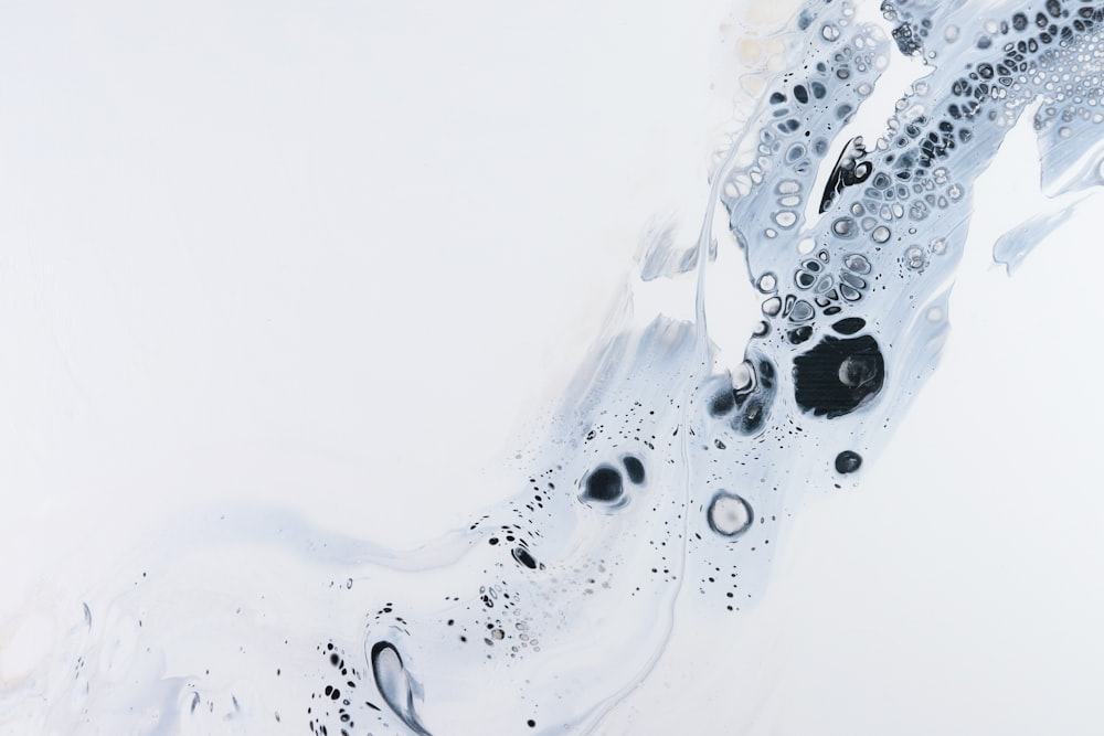 a white and black abstract painting with bubbles