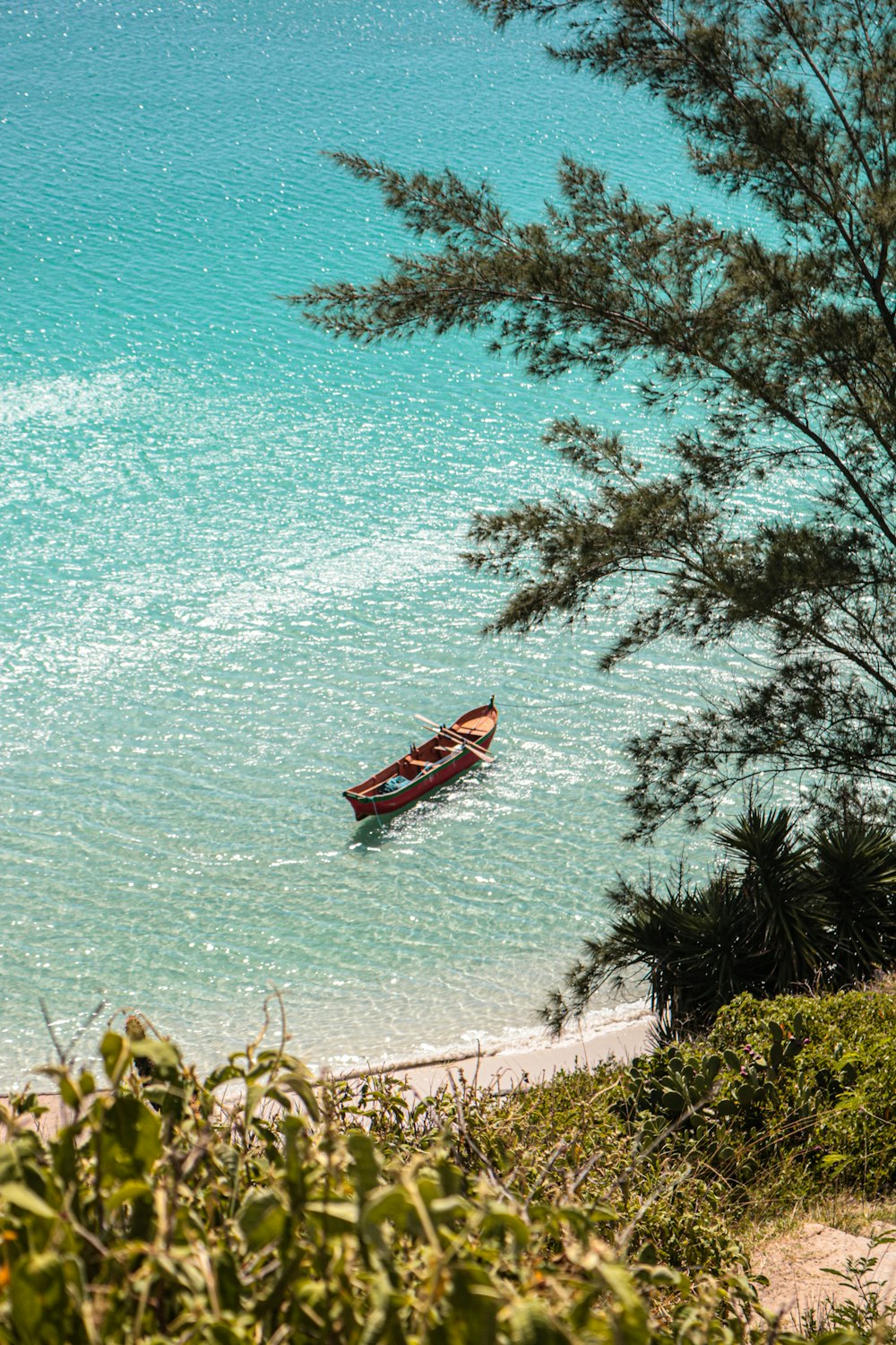 a couple of boats floating on top of a body of water