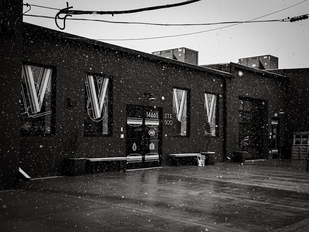 a black and white photo of a building in the snow