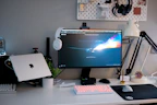 A variety of computer accessories including keyboards, mice, and headphones arranged neatly on a desk.