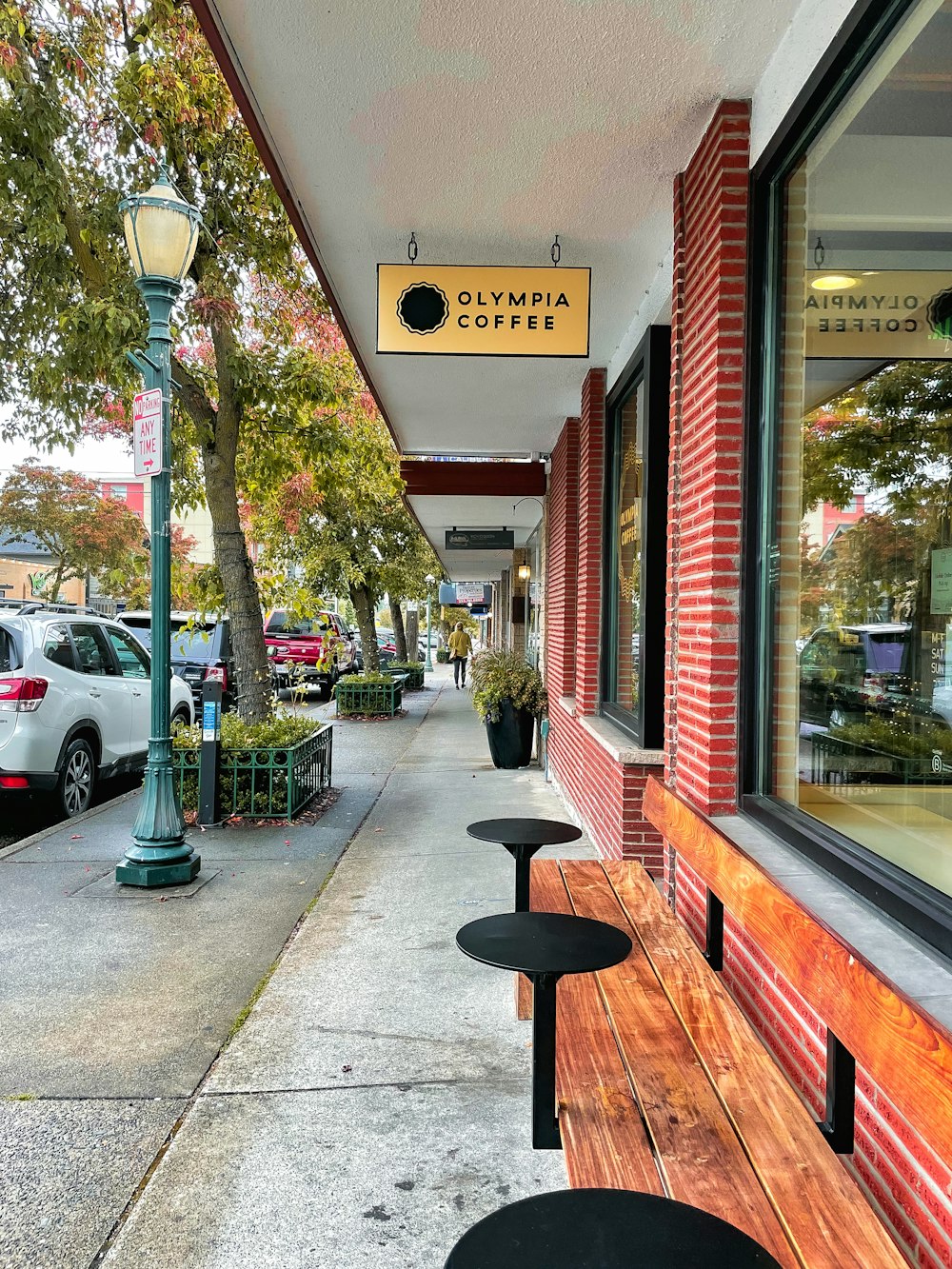 a row of benches sitting on the side of a street