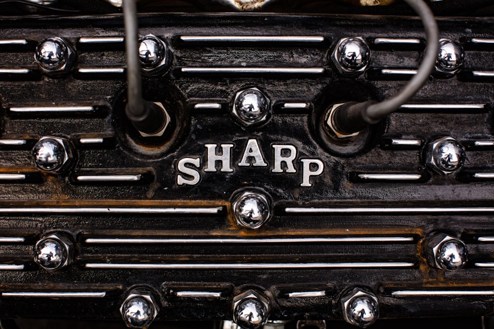 a close up of a metal object with the word sharp on it