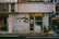 Wide shot of the RR Garagem storefront with clean, minimalist design and clear signage.