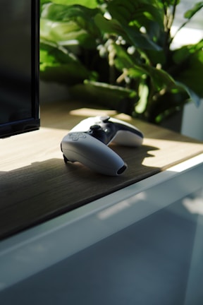 a couple of remotes sitting on top of a table