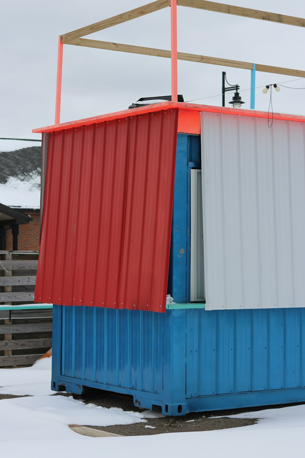 a red, white and blue building sitting in the snow