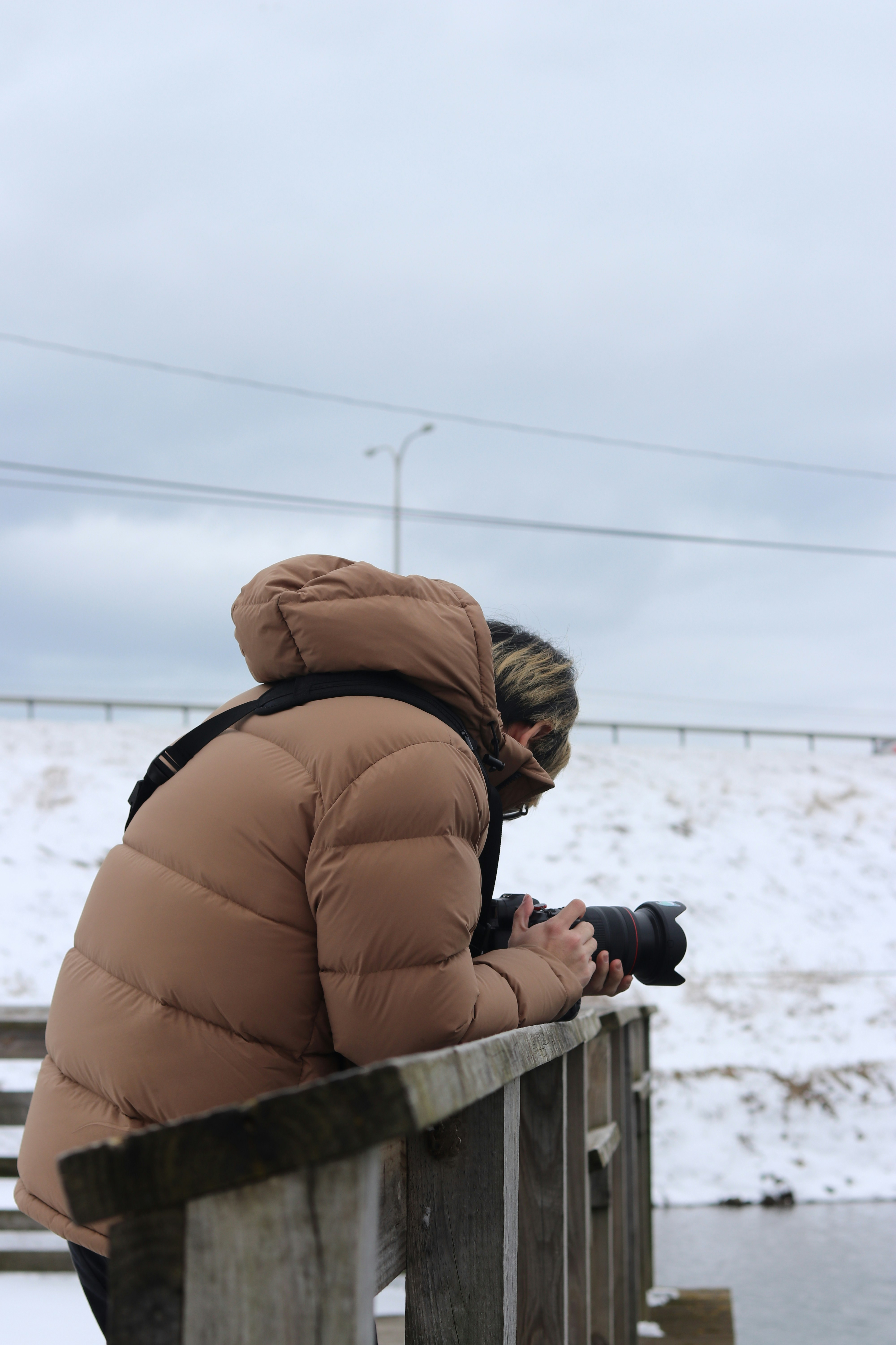 a woman sitting on a bench looking at her cell phone