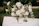 Handcrafted wooden wedding welcome sign with elegant floral decorations in a rustic setting.