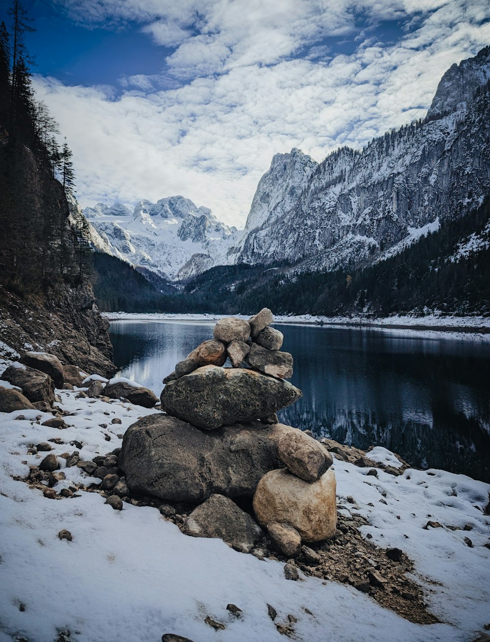 a pile of rocks sitting on top of a snow covered ground