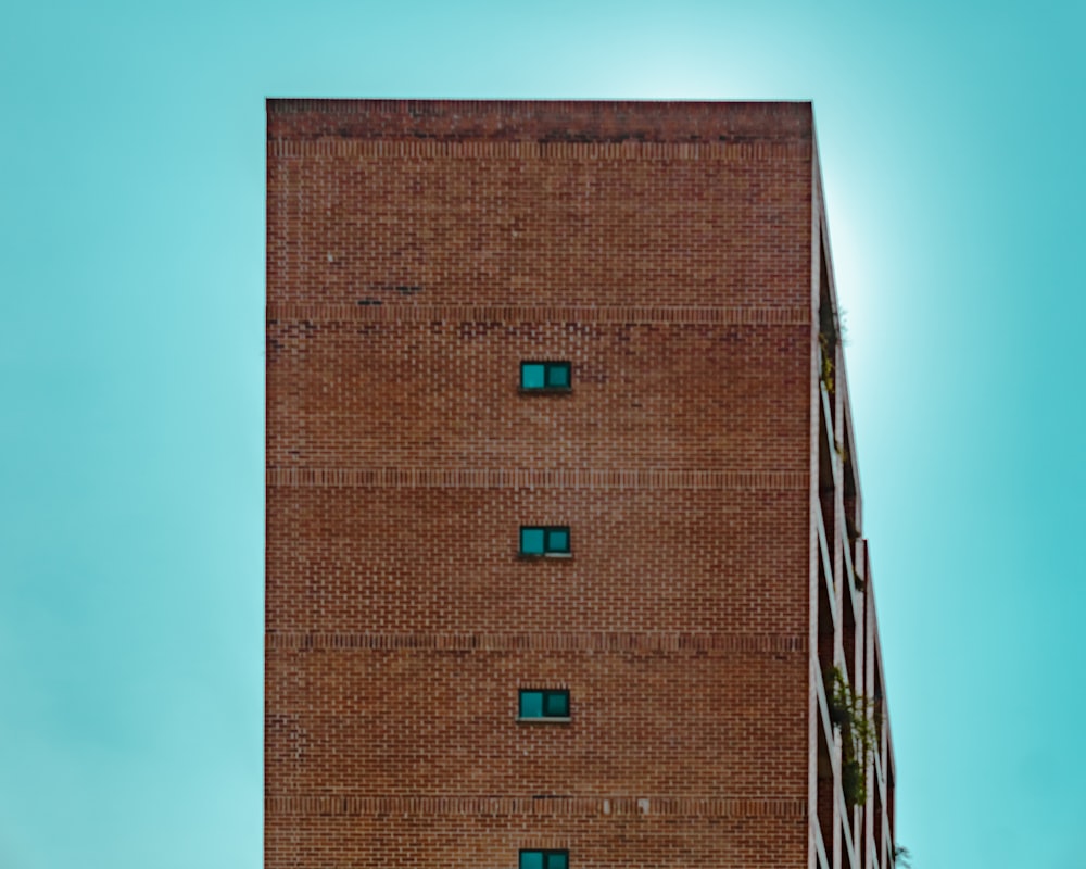 a tall brick building with a clock on the side of it