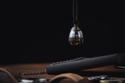 Close-up of a sleek, futuristic time capsule device glowing softly in a dark room