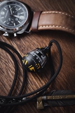 A stylish flat lay of several vintage watches arranged on a textured cream background with a subtle grain effect.