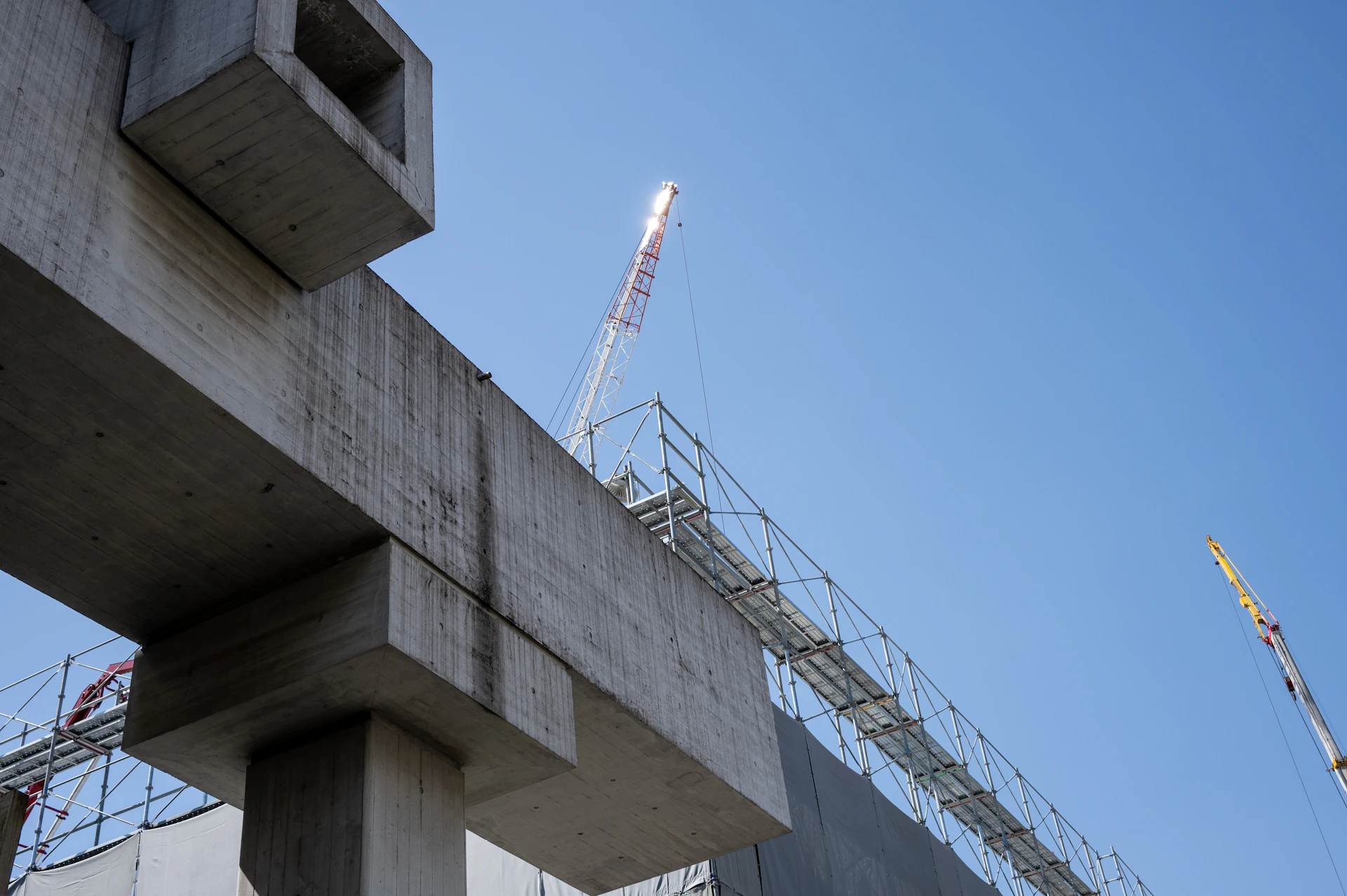 a crane is on top of a building under construction