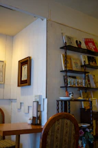 A cozy, sunlit interior corner featuring elegant handmade decor and a sketchbook on a wooden table.