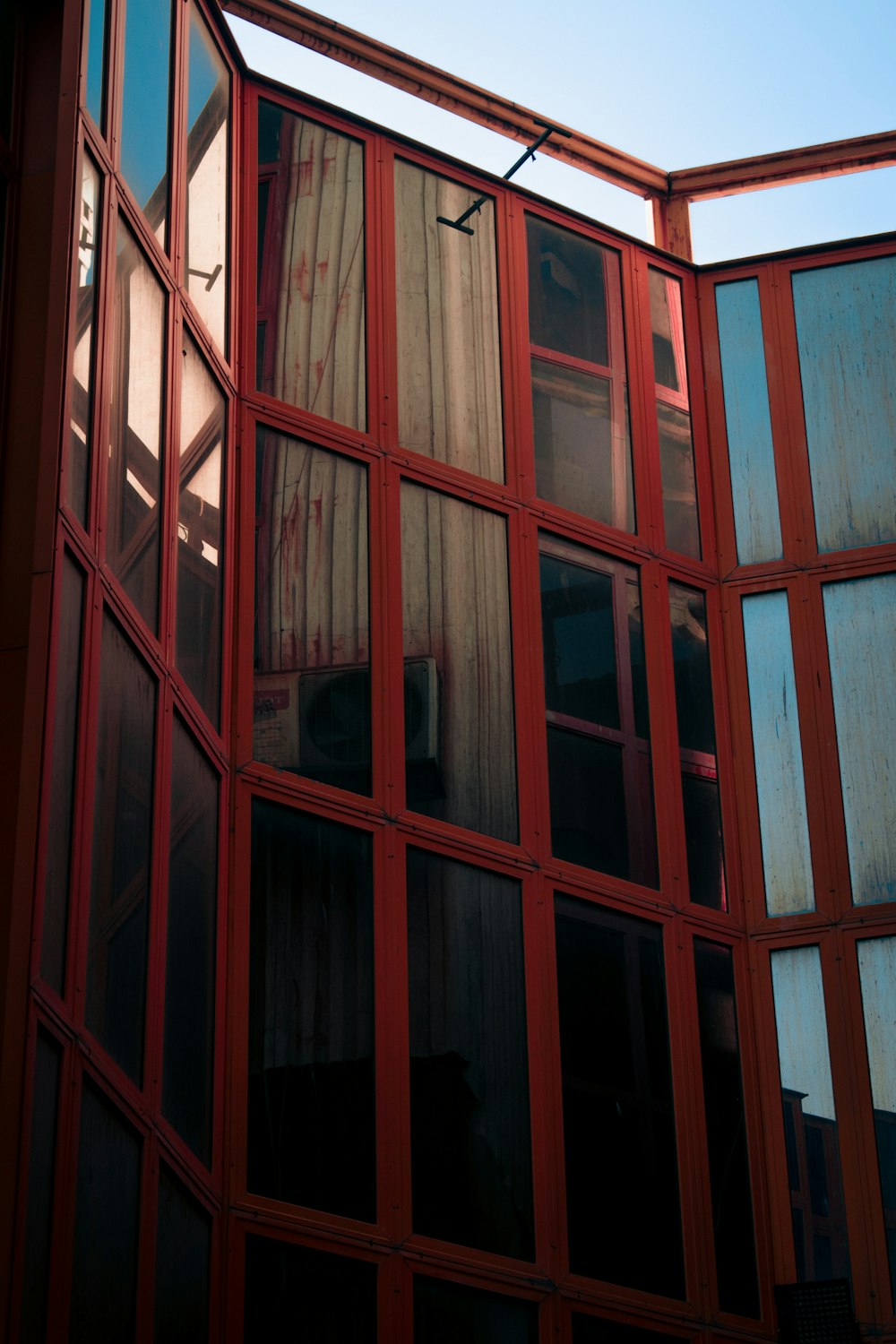 a red building with a clock on the side of it