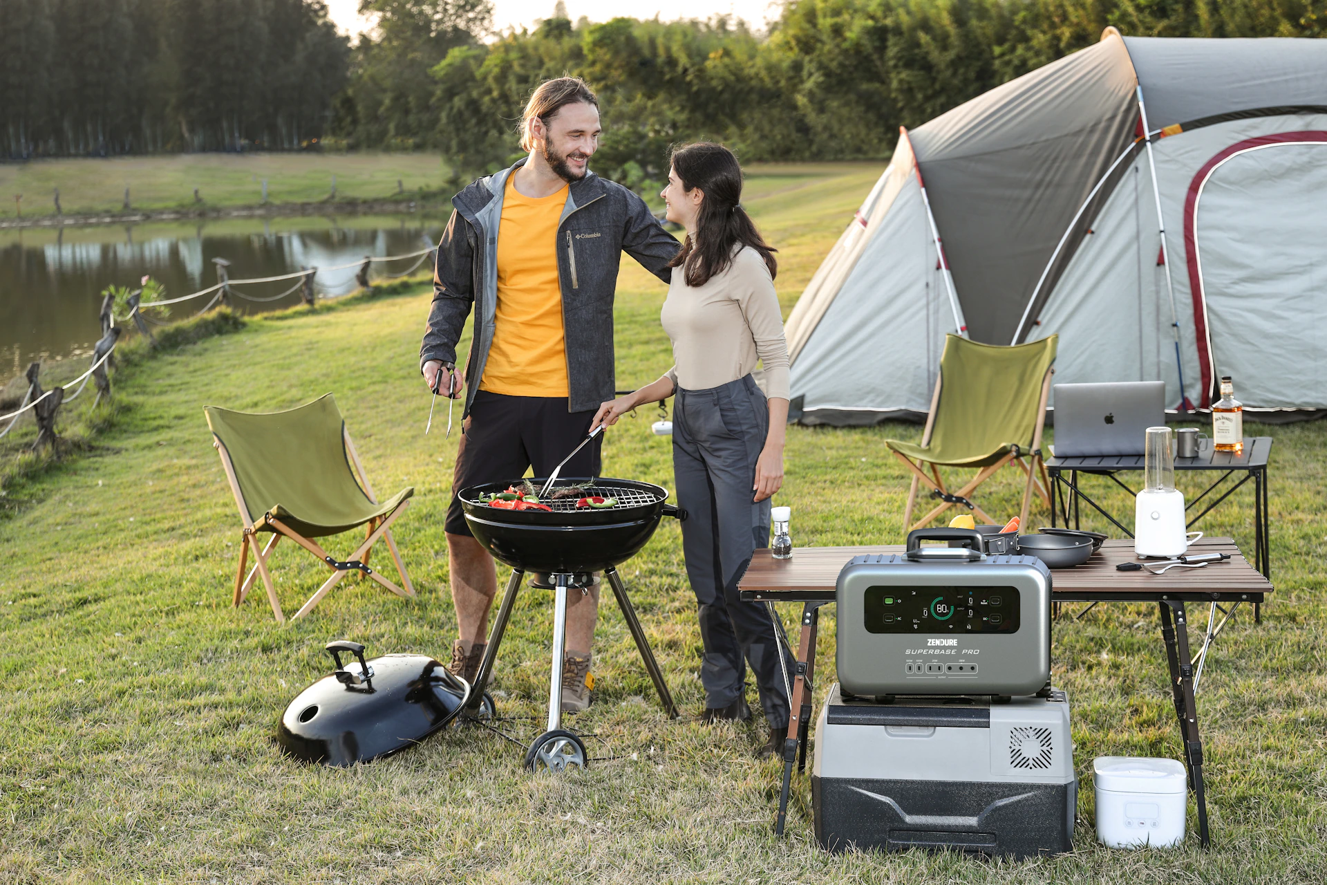 a man and a woman standing next to a grill