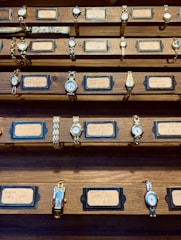 a collection of watches on display in a wooden case