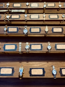 a collection of watches on display in a wooden case