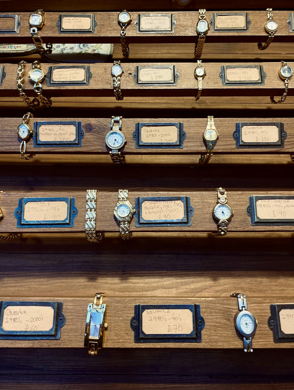 a collection of watches on display in a wooden case