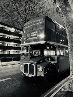 a black and white photo of a double decker bus