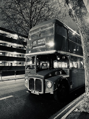 a black and white photo of a double decker bus