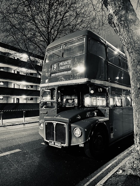 a black and white photo of a double decker bus
