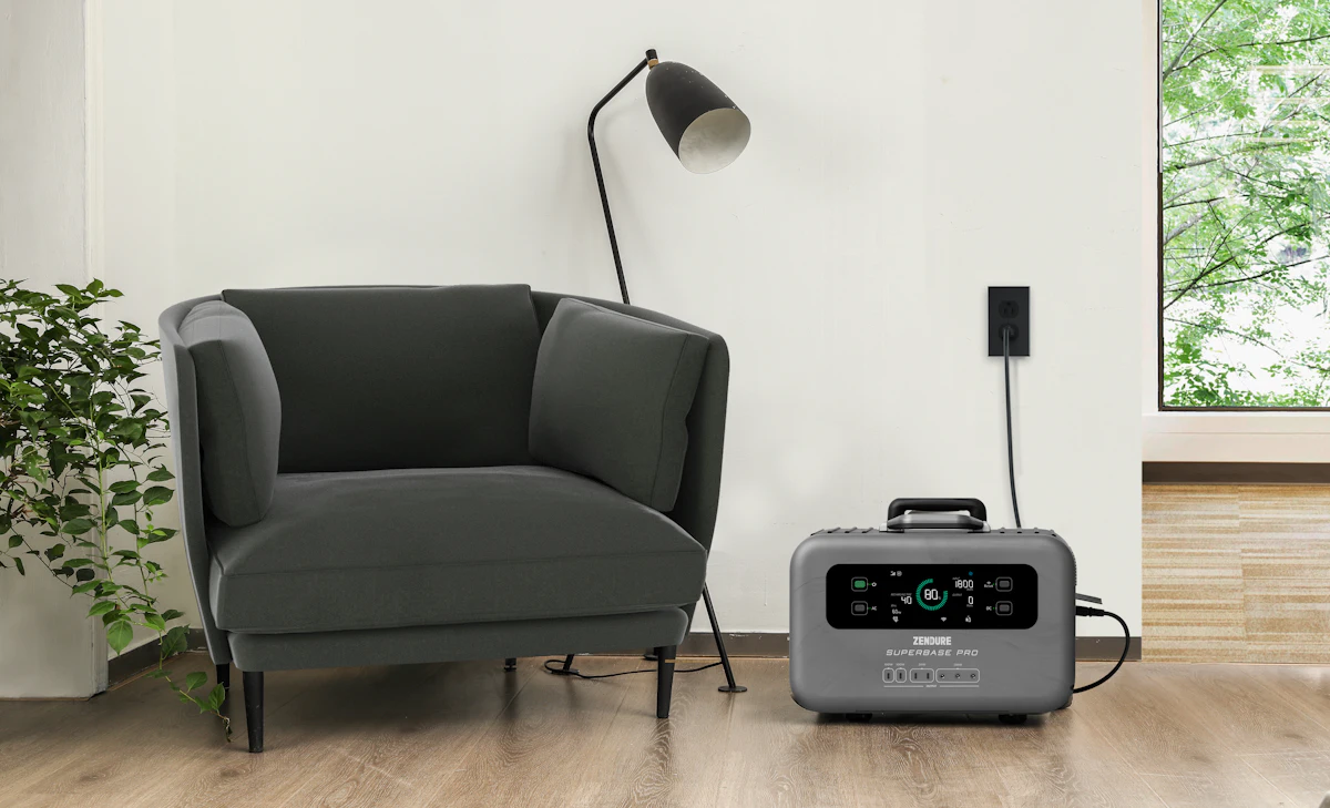 Portable power station plugged in beside an armchair at home