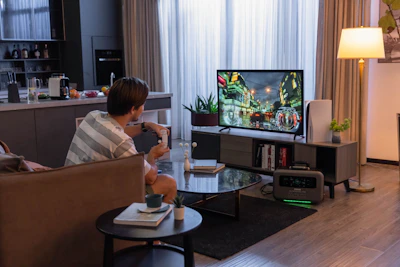 a man sitting in a chair in front of a tv