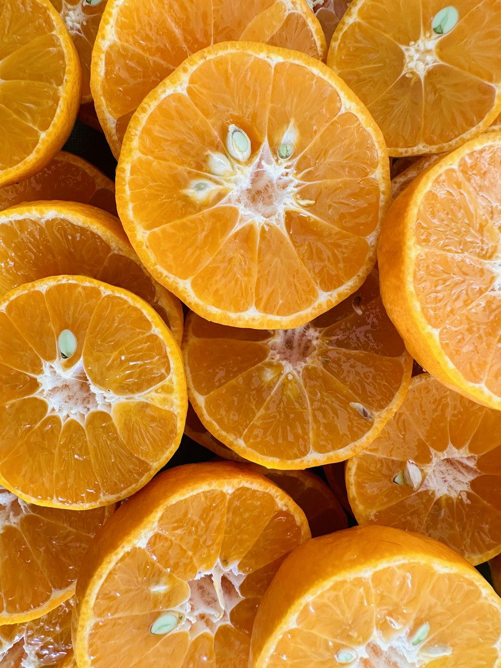 a bunch of oranges that are cut in half