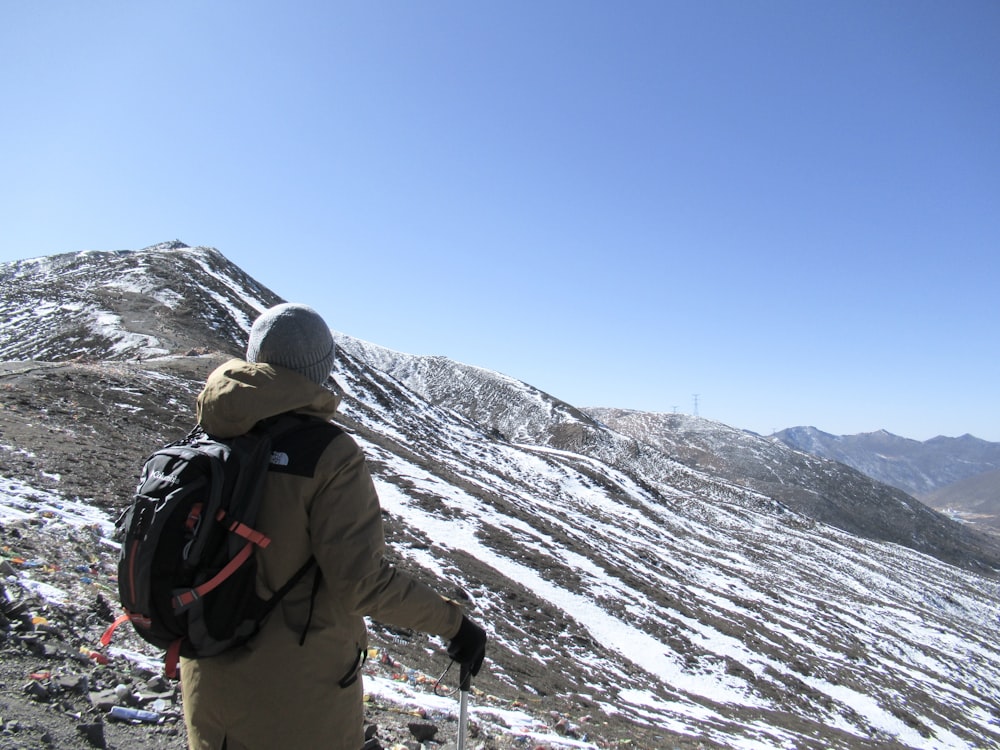 a man standing on top of a snow covered mountain